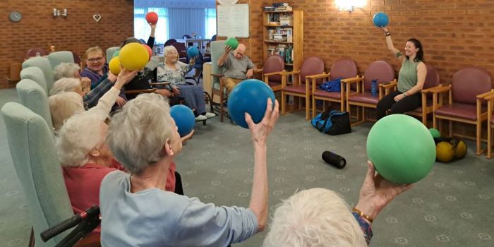 Residents of Gretton court doing seating exercises