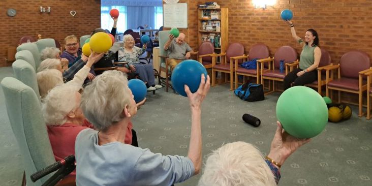 Residents of Gretton court doing seating exercises