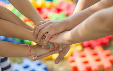 Group of people putting their hands together